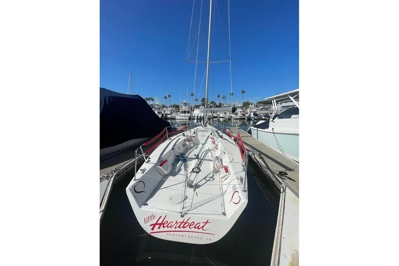Slide: The Image of 1997 Beneteau 25 Platu sailboat docked in Newport Beach marina under clear blue sky. - 4