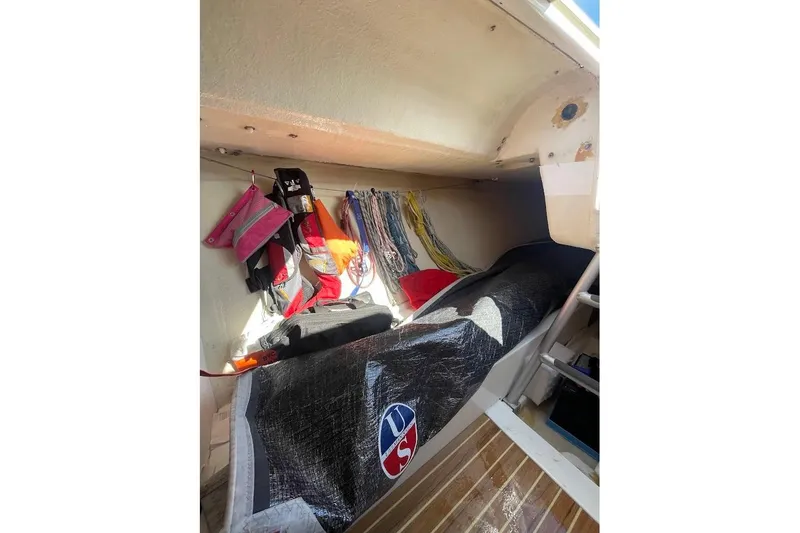 Slide: The Image of Interior storage of 1997 Beneteau 25 Platu sailboat with ropes and gear. - 9
