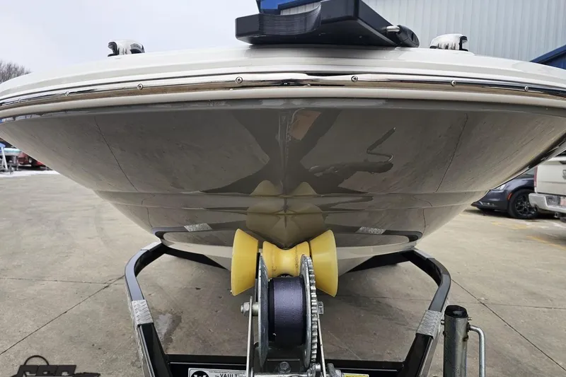Slide: The Image of 2022 Stingray 182 SC boat on trailer, front view, parked outdoors. - 13