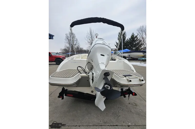 Slide: The Image of 2022 Stingray 182 SC boat, rear view with outboard motor and swim platform. - 27