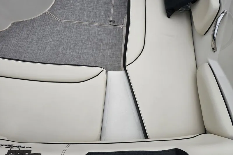 Slide: The Image of Interior seating of a 2022 Stingray 182 SC boat, featuring white upholstery and gray flooring. - 38