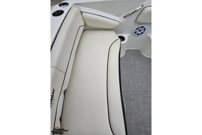 Slide: The Image of 2022 Stingray 182 SC boat interior with cushioned seating and cup holders. - 40