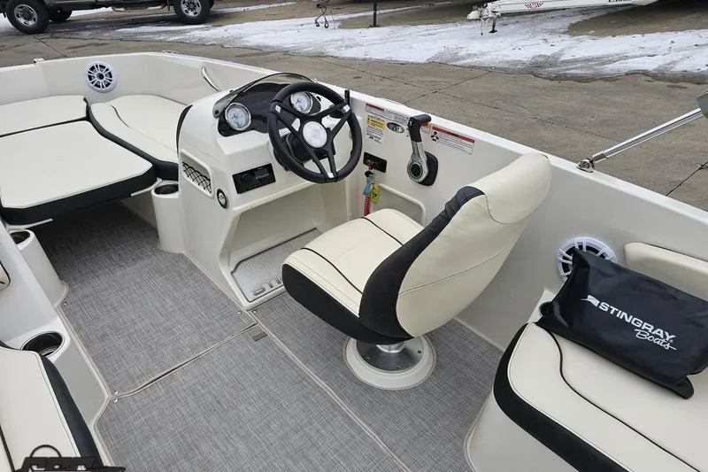 Slide: The Image of 2022 Stingray 182 SC boat interior with steering wheel, seating, and dashboard controls. - 46