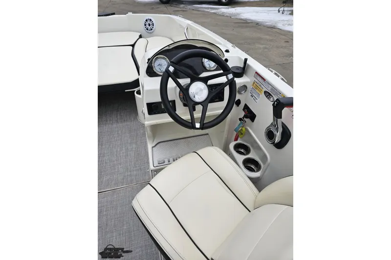 Slide: The Image of 2022 Stingray 182 SC boat interior with steering wheel and seating. - 50