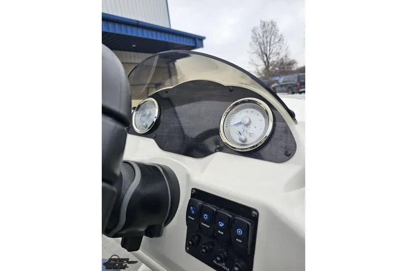 Slide: The Image of 2022 Stingray 182 SC dashboard with gauges and controls, outdoor setting. - 57
