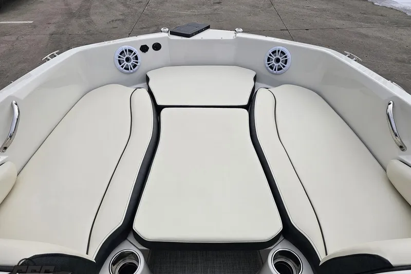 Slide: The Image of 2022 Stingray 182 SC boat interior with white cushioned seating and speakers. - 60