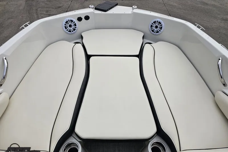 Slide: The Image of 2022 Stingray 182 SC boat interior with white cushioned seating and speakers. - 61
