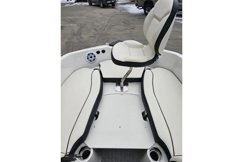 Slide: The Image of 2022 Stingray 182 SC boat interior with white seating and cup holders. - 63
