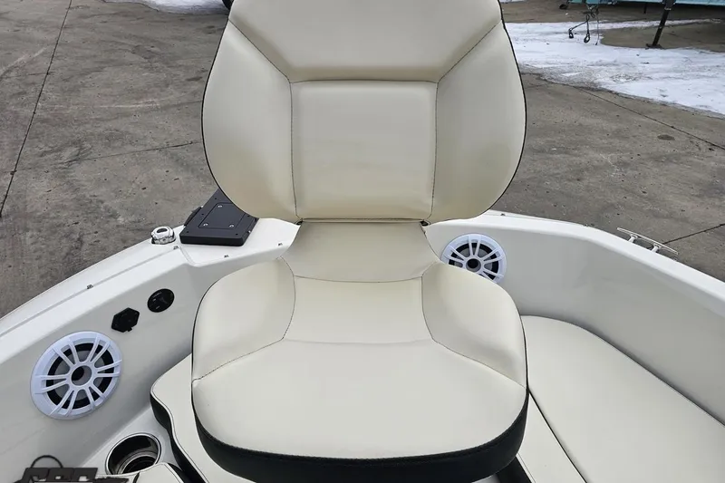 Slide: The Image of 2022 Stingray 182 SC boat seat with white upholstery and built-in speakers. - 64