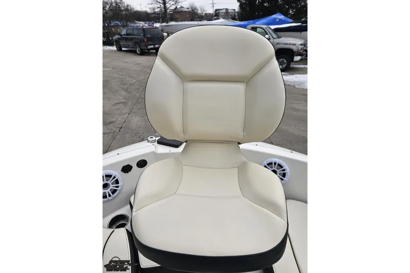 Slide: The Image of 2022 Stingray 182 SC boat seat with beige upholstery and speaker in background. - 65
