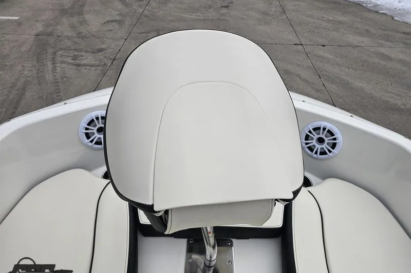 Slide: The Image of 2022 Stingray 182 SC boat interior with white seating and speakers. - 66