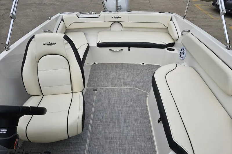 Slide: The Image of 2022 Stingray 182 SC boat interior with white seating and gray flooring. - 73