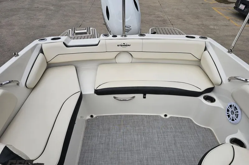 Slide: The Image of 2022 Stingray 182 SC boat interior with white cushioned seating and modern design. - 80