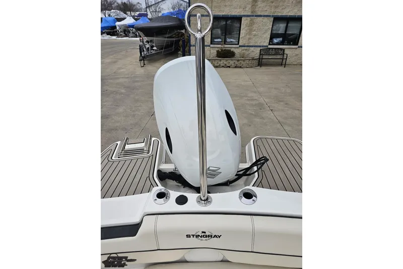 Slide: The Image of 2022 Stingray 182 SC boat with sleek design and modern features, docked outdoors. - 82