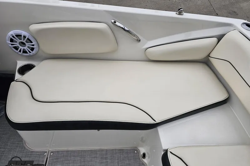 Slide: The Image of 2022 Stingray 182 SC boat interior with cushioned seating and speaker. - 86