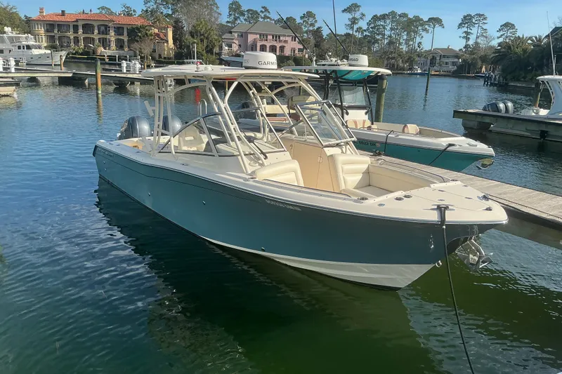 The Image of 2020 Grady-White Freedom 275 boat docked in a scenic marina setting. - 1