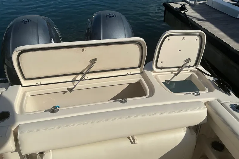 Slide: The Image of 2020 Grady-White Freedom 275 boat with open storage compartments at the stern. - 10