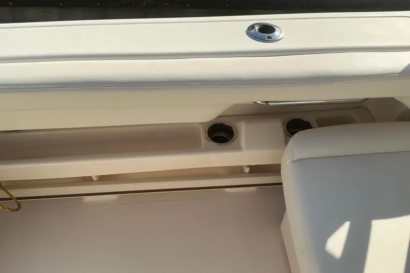 Slide: The Image of Interior of 2020 Grady-White Freedom 275 boat, featuring seating and cup holders. - 14