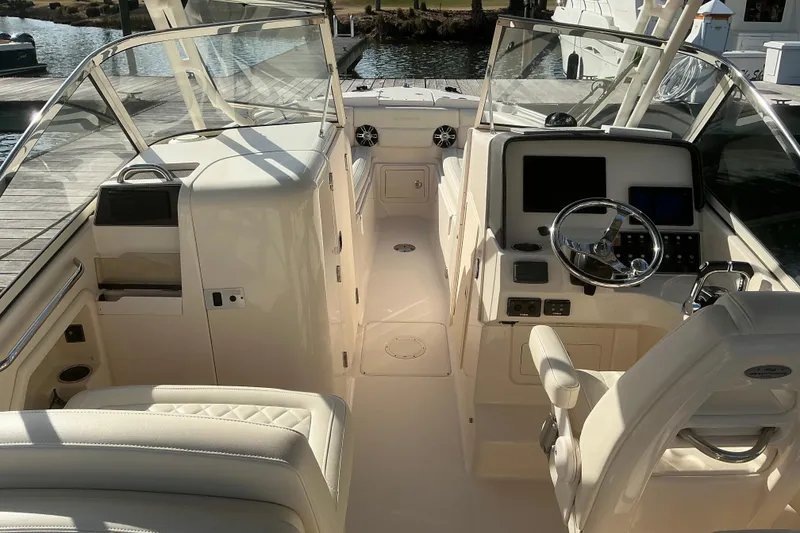 Slide: The Image of 2020 Grady-White Freedom 275 boat interior with helm and seating area. - 15