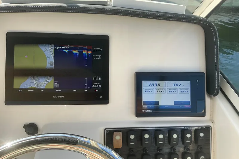 Slide: The Image of Dashboard of 2020 Grady-White Freedom 275 with Garmin and Yamaha displays. - 16
