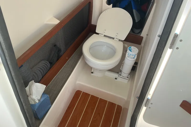 Slide: The Image of 2020 Grady-White Freedom 275 boat bathroom with toilet and wooden flooring. - 22