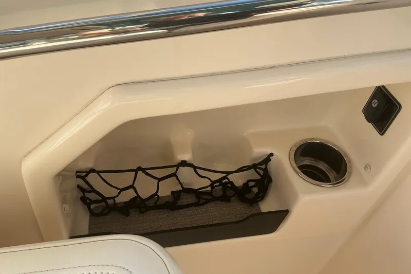 Slide: The Image of 2020 Grady-White Freedom 275 boat interior with storage net and cup holder. - 23