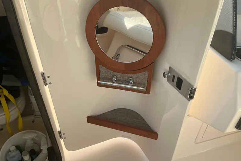 Slide: The Image of Interior of 2020 Grady-White Freedom 275 boat with mirror and storage compartment. - 24
