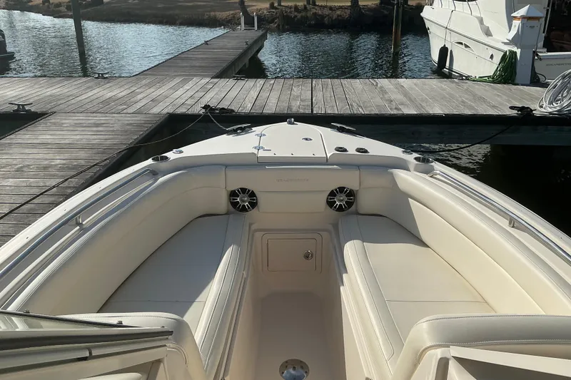 Slide: The Image of 2020 Grady-White Freedom 275 boat interior at dock, featuring spacious seating and sleek design. - 26