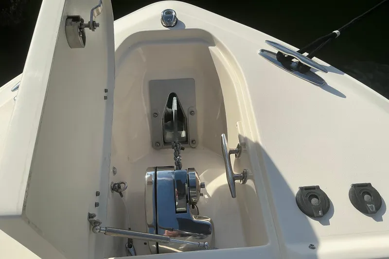 Slide: The Image of Anchor compartment of 2020 Grady-White Freedom 275 boat, featuring a polished winch system. - 28