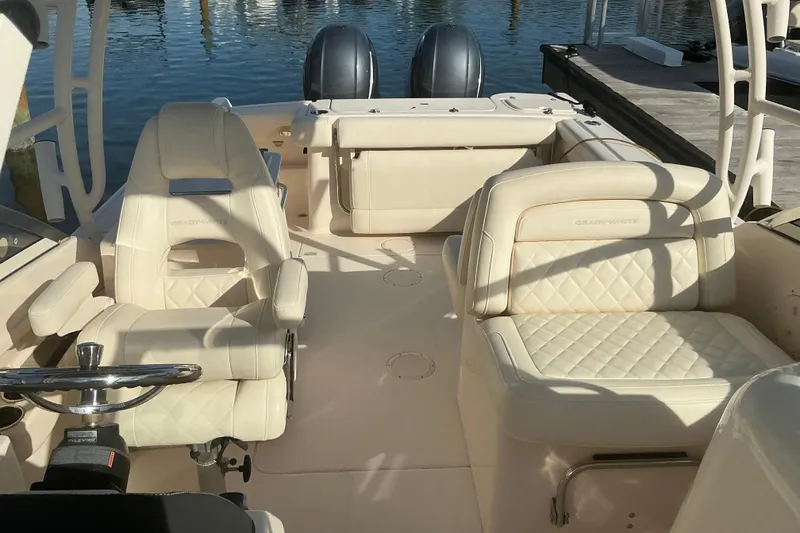Slide: The Image of 2020 Grady-White Freedom 275 boat interior with luxurious seating and dual engines. - 29