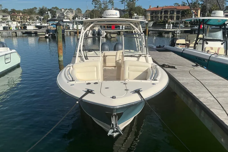 Slide: The Image of 2020 Grady-White Freedom 275 boat docked at marina, featuring Garmin equipment. - 3