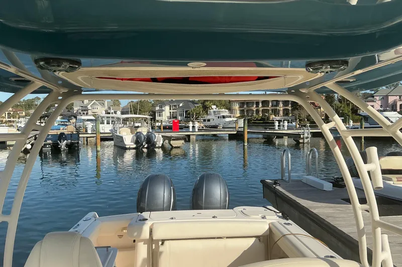 Slide: The Image of 2020 Grady-White Freedom 275 boat docked at a marina with scenic waterfront view. - 30