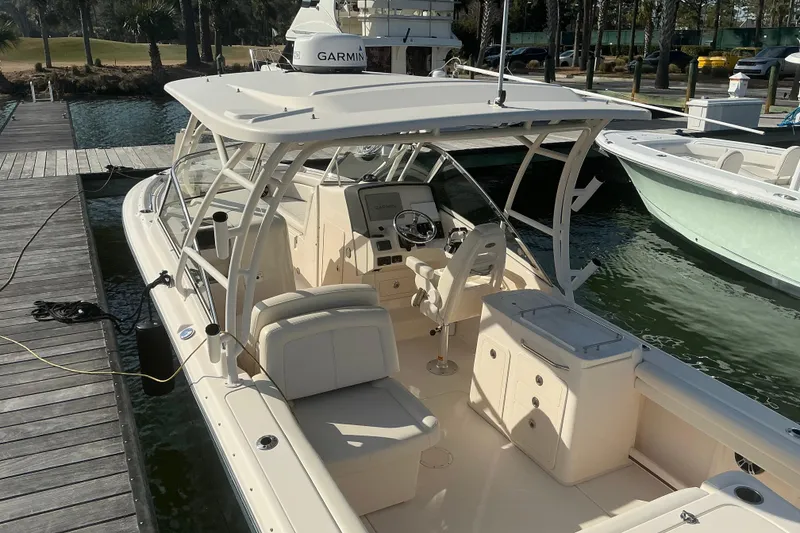 Slide: The Image of 2020 Grady-White Freedom 275 boat docked, featuring spacious seating and modern controls. - 5