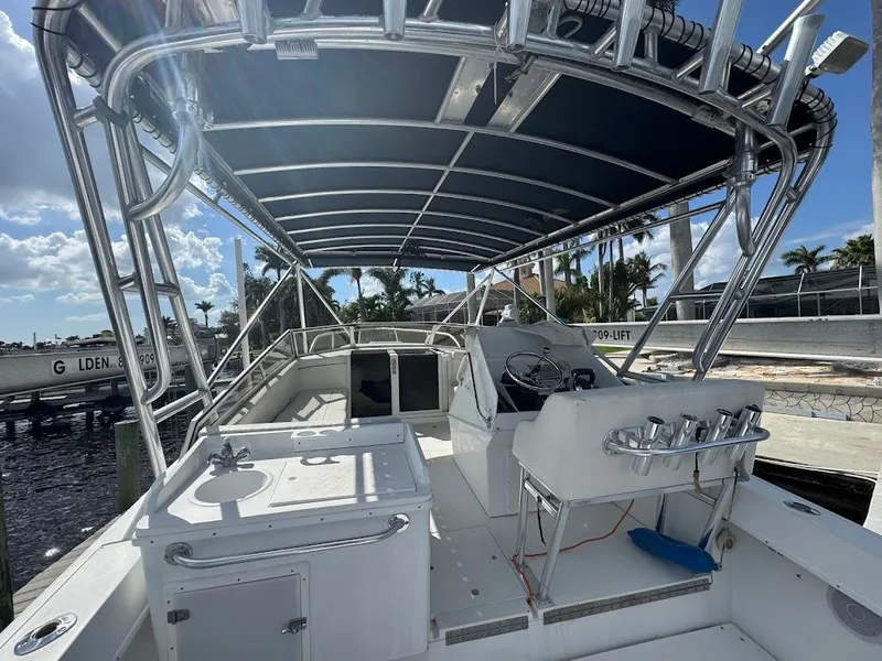 Slide: The Image of 2001 Contender 35 Side Console boat with canopy and fishing rod holders. - 13