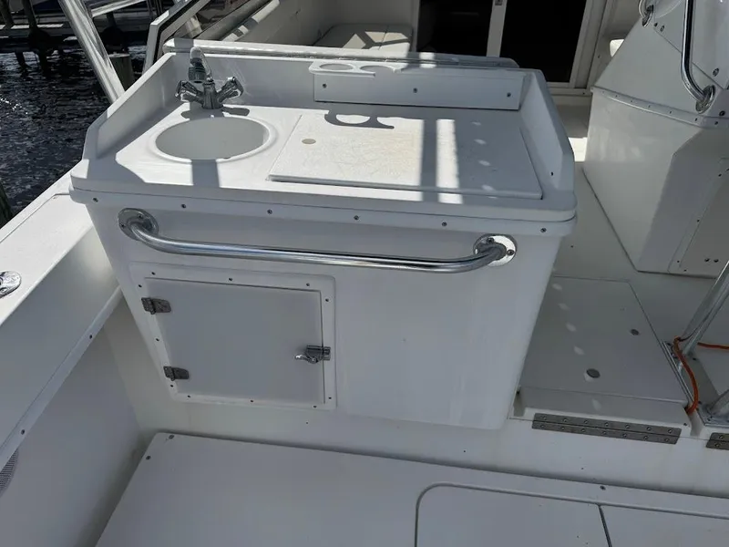 Slide: The Image of 2001 Contender 35 Side Console boat sink and storage area. - 14