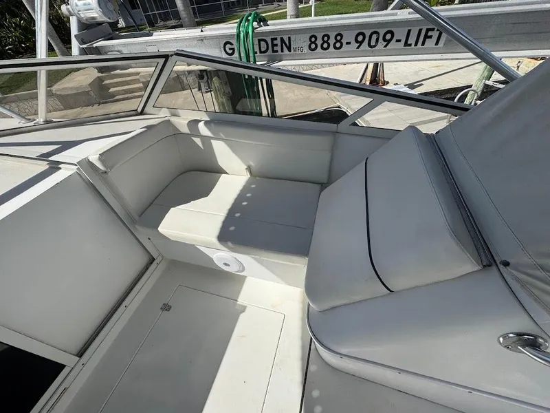 Slide: The Image of 2001 Contender 35 Side Console boat interior with white seating and railing. - 16