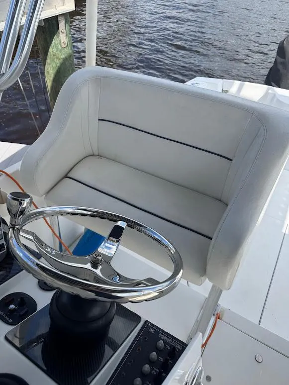 Slide: The Image of 2001 Contender 35 Side Console helm seat with chrome steering wheel, docked by the water. - 17