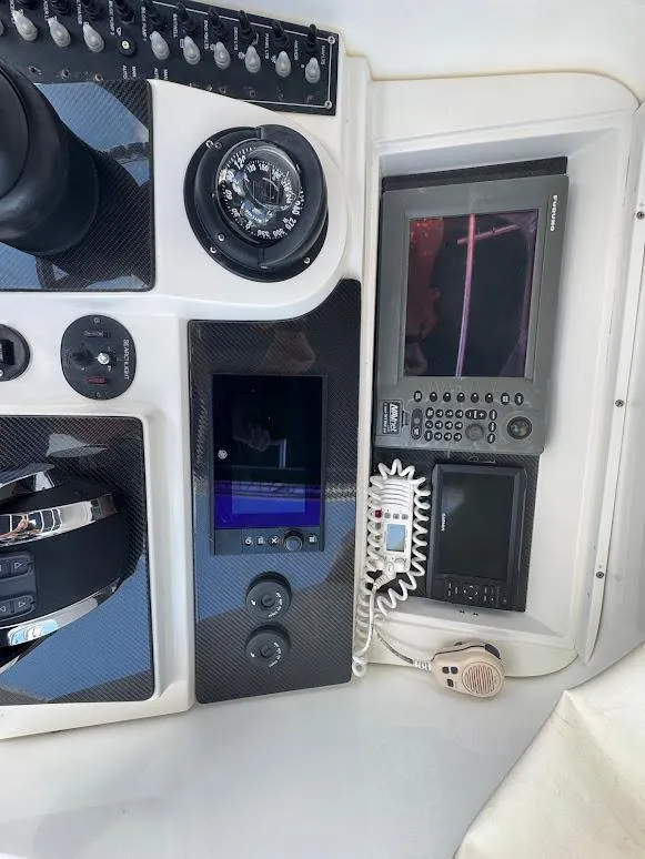 Slide: The Image of Control panel of a 2001 Contender 35 Side Console boat with navigation instruments. - 18
