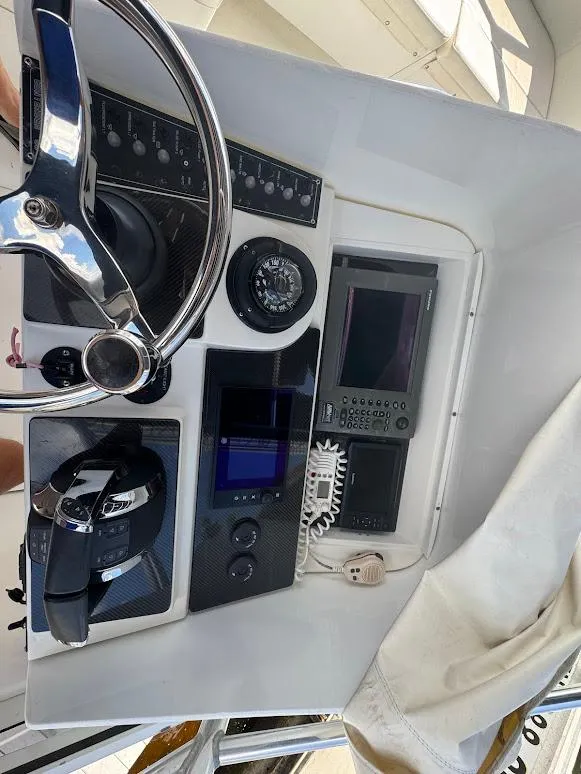 Slide: The Image of 2001 Contender 35 Side Console dashboard with steering wheel and navigation instruments. - 19