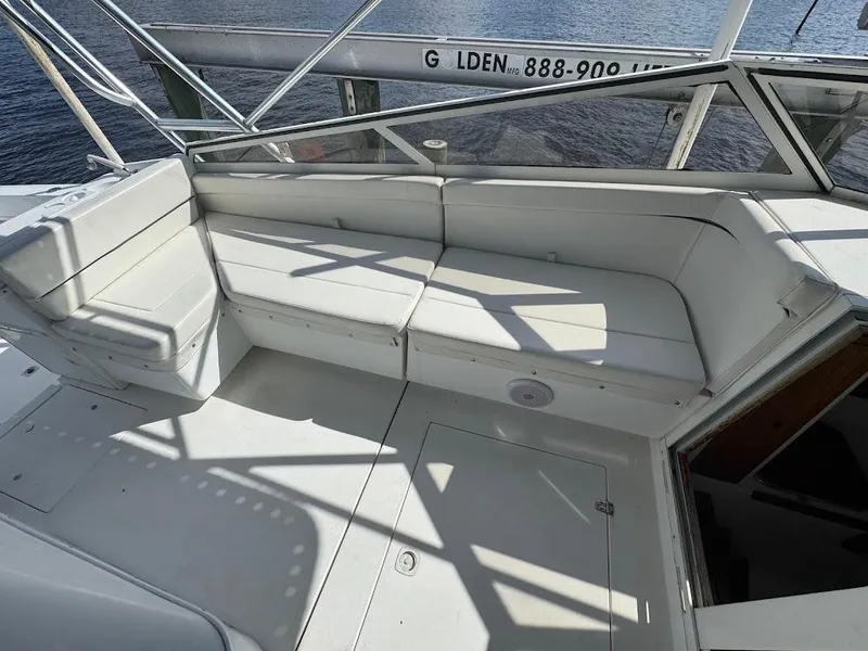 Slide: The Image of 2001 Contender 35 Side Console boat with white seating and open deck area. - 20