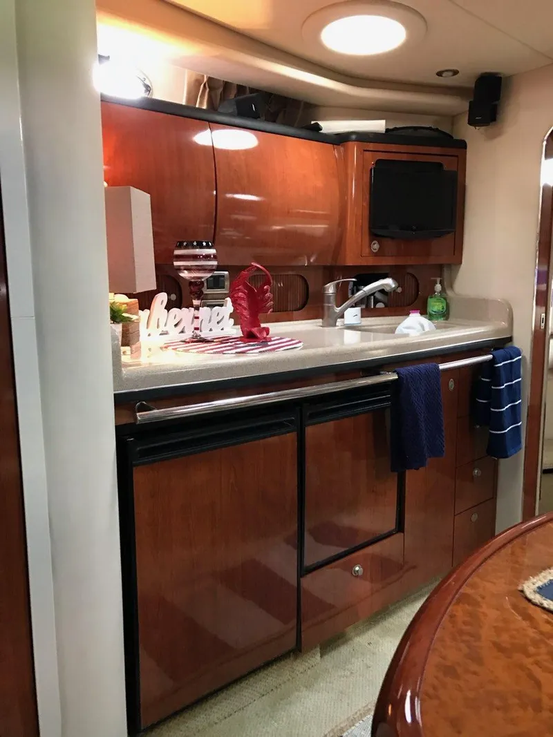 Slide: The Image of Interior of 2004 Sea Ray 360 Sundancer featuring elegant kitchen. - 13