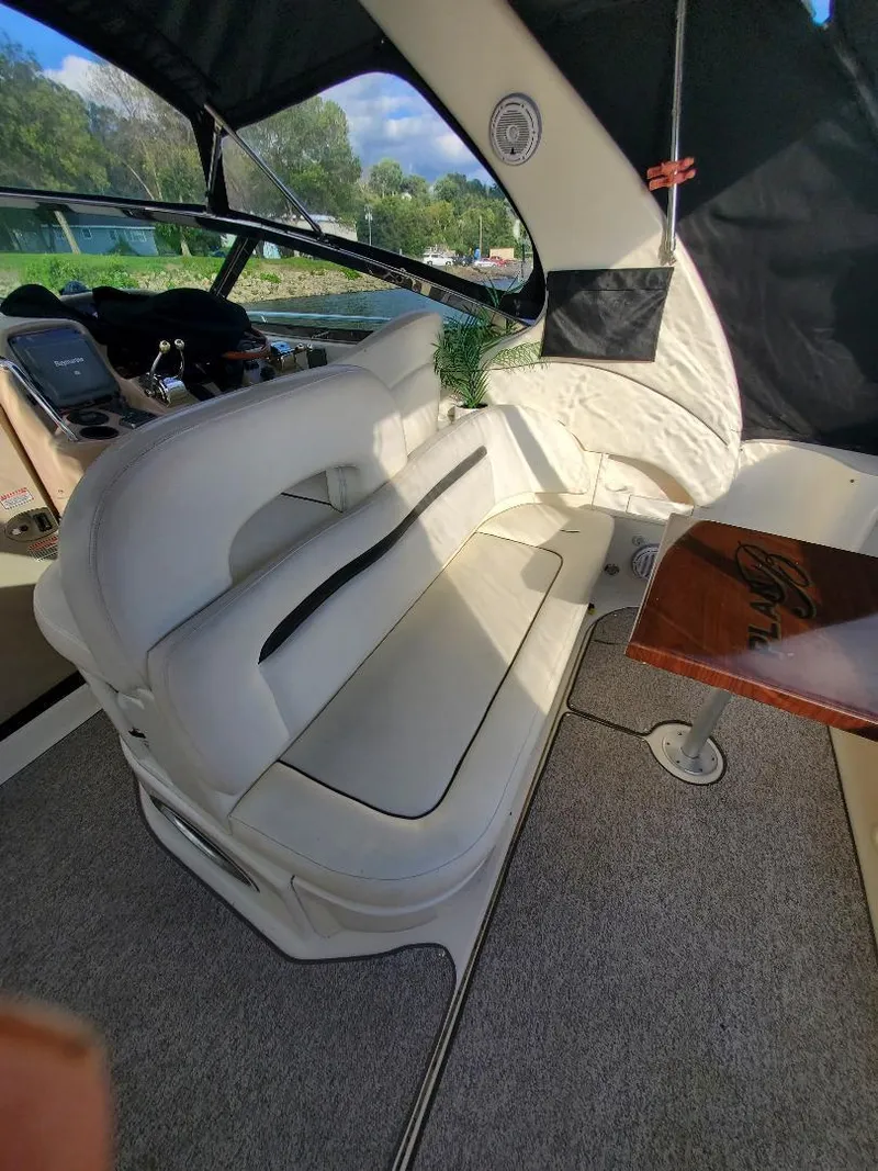 Slide: The Image of Interior of a 2004 Sea Ray 360 Sundancer with white seating area. - 2