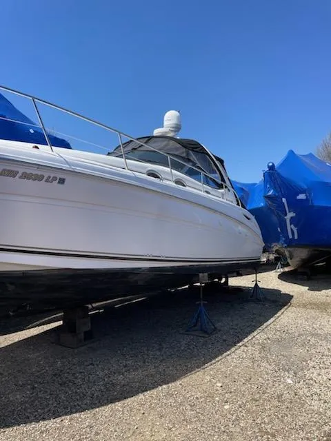 Slide: The Image of 2004 Sea Ray 360 Sundancer boat on stands outdoors. - 6