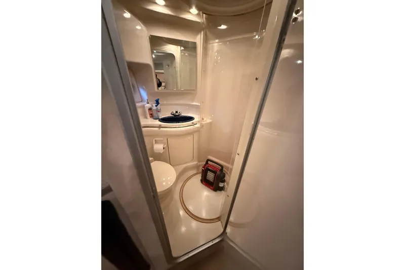 Slide: The Image of Bathroom interior of 1998 Bayliner 3685 Avanti Sunbridge yacht, featuring compact design and amenities. - 10