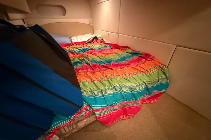 Slide: The Image of Cozy cabin interior of 1998 Bayliner 3685 Avanti Sunbridge with colorful bedding. - 11