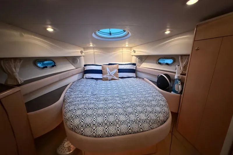 Slide: The Image of Luxurious cabin interior of 1998 Bayliner 3685 Avanti Sunbridge with cozy bed and ambient lighting. - 2