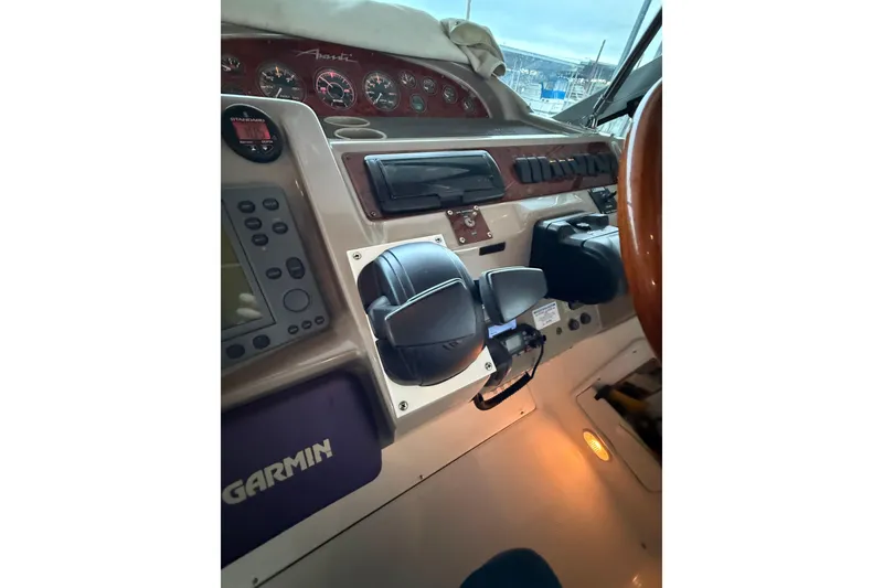 Slide: The Image of 1998 Bayliner 3685 Avanti Sunbridge helm with Garmin navigation system and controls. - 23