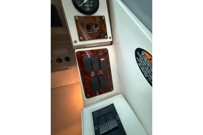 Slide: The Image of 1998 Bayliner 3685 Avanti Sunbridge control panel with switches and gauges. - 25