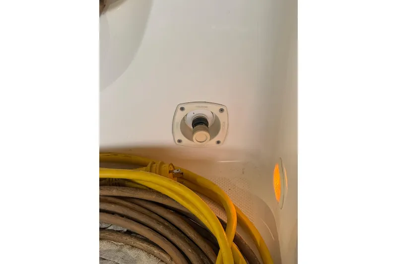 Slide: The Image of 1998 Bayliner 3685 Avanti Sunbridge deck with coiled hoses and a water connection. - 39
