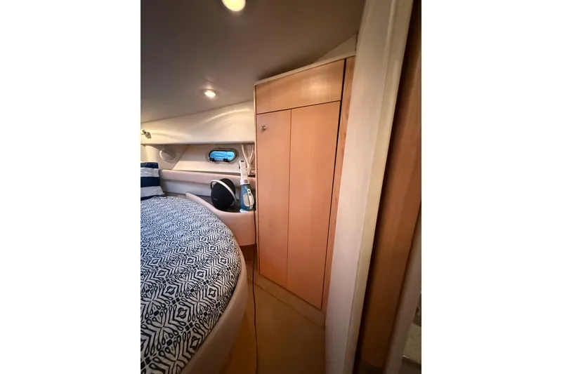 Slide: The Image of 1998 Bayliner 3685 Avanti Sunbridge cabin interior with bed and storage. - 4